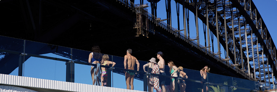 Visitors on the pool deck under the Sydney Harbour Bridge
